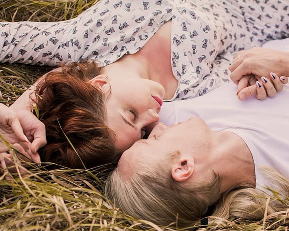 1593058485 woman in white shirt lying on brown grass