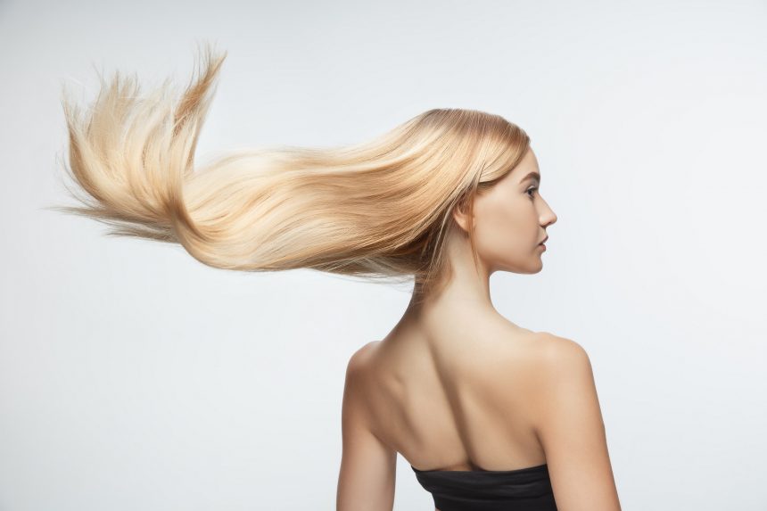 beautiful model with long smooth flying blonde hair isolated white studio background young caucasian model with well kept skin hair blowing air 860x573