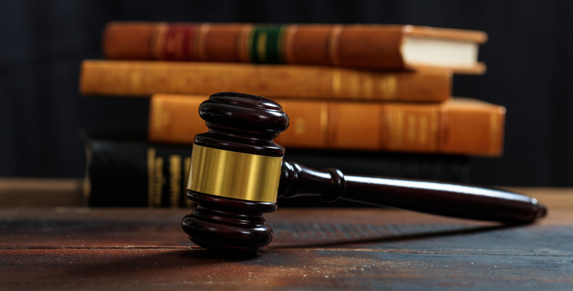 judge gavel on a wooden desk law books background P75HKF7 min